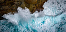Blue-green Waves Crashing On Cliff