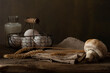 Food background with farm products. Eggs, bottle with milk, mushroom, wheat earnes on rustic wooden table.