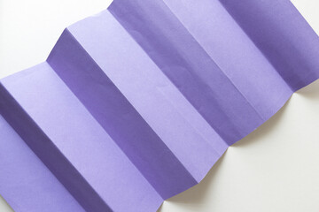 violet pleated construction paper - photographed from above - blank space for text