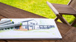 Gartengestaltung - Planung vor Ort - Zeichnung von Haus und Garten liegt mit Stiften auf einem Gartentisch