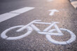 © Viesturs - Separate bicycle lane for riding bicycles. A white bicycle symbol on the road. Selective focus