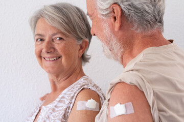 Beautiful smiling senior couple 70s after receiving the coronavirus covid-19 vaccine.