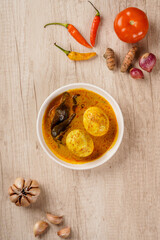 Wall Mural - Top of View Gulai telur or eggs serve with curry sauce, Gulai Telur is traditional food of Indonesia from Padang, West Sumatera.
