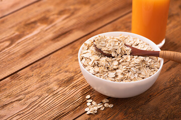 Sticker - Oatmeal grain in a white bowl on wooden table