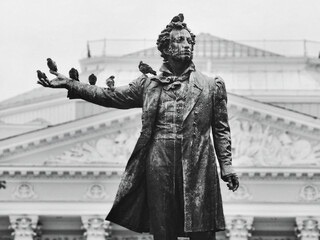 Pigeons sit on the monument to Alexandr Pushkin