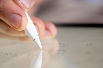 Young mathematics scientist writing math formulas on a digital tablet