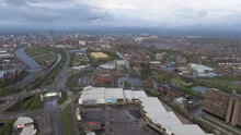 Manchester Urban Skyline Aerial View Around Trafford Town Flying Towards To City Center Ft. Suburban Neighborhood And Residential Buildings And River In England, United Kingdom 4K