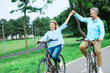 senior couple happy elderly love together retirement bicycle bike man woman mature fun