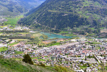 Aerial View On A City In European Alps Crossing By A River