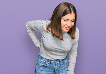 Canvas Print - Young beautiful woman wearing casual turtleneck sweater suffering of backache, touching back with hand, muscular pain