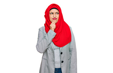 Sticker - Beautiful hispanic woman wearing traditional islamic hijab scarf serious face thinking about question with hand on chin, thoughtful about confusing idea