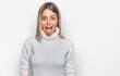 © Krakenimages.com - Beautiful blonde woman wearing casual turtleneck sweater sticking tongue out happy with funny expression. emotion concept.