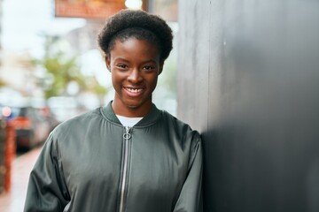 Poster - Young african american girl smiling happy standing at the city.