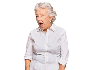 Senior grey-haired woman wearing casual clothes winking looking at the camera with sexy expression, cheerful and happy face.