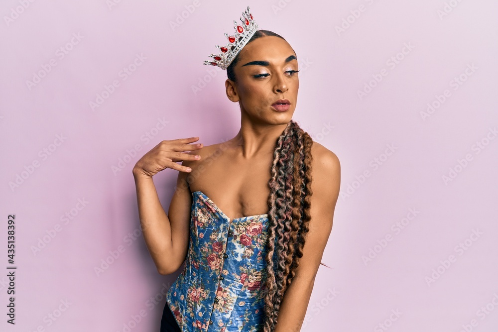 Sensual hispanic transgender woman wearing queen crown and posing glamorous with seductive face wearing sexy lingerie - obrazy, fototapety, plakaty 