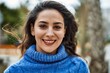 © Krakenimages.com - Young hispanic woman smiling happy standing at the city.