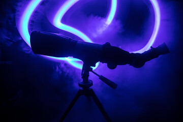 Wall Mural - silhouette of a astronomy telescope on dark foggy backlight.