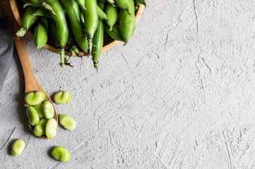 Fresh broad beans with pod on rustic background, healthy food