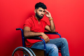 Sticker - Arab man with beard sitting on wheelchair worried and stressed about a problem with hand on forehead, nervous and anxious for crisis