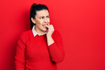 Sticker - Young hispanic woman wearing casual clothes looking stressed and nervous with hands on mouth biting nails. anxiety problem.