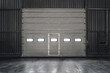 Overhead sectional gate inside an industrial building . Grey lift door.