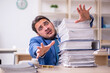 © Elnur - Young businessman employee and too much work in the office