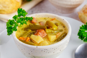 Wall Mural - Vegetable soup made from cut green beans, carrot, potato and ham.