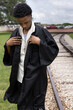 Young African American Male High School Senior Graduation Cap and Gown Celebration 2021