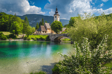 Wall Mural - Traditional alpine church on the shore of the lake Bohinj