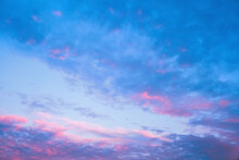 Beautiful Blue Cloudy Sky, Feathery Clouds Illuminated By The Pink Rays Of Dawn