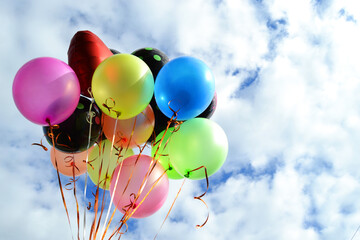 colorful balloons on a background of blue sky and clouds