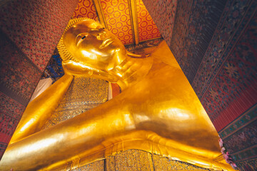 the image of gold reclining buddha in capital palace wat pho temple bangkok thailand