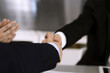 © Iryna - Business people shaking hands after contract signing in modern office. Teamwork and handshake concept