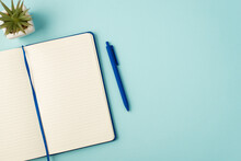 Top View Photo Of Open Blue Notepad Pen And Plant On Isolated Pastel Blue Background With Blank Space