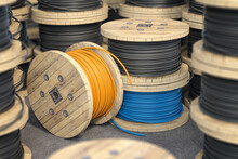 Wire Electric Cable On Wooden Coil Or Spool Isolated On Warehouse.