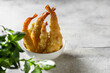 Delicious shrimp tempura on light gray concrete background. Breaded prawns.