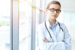 © volha_r - Beautiful woman doctor with stethoscope smiling charmingly and ready to help patients in sunny hospital. Medicine concept