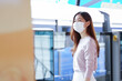 © Pruksachat - Young Asian business woman wearing face mask in casual sweater is waiting for the train to go to work on the platform station. New normal lifestyle in city concept