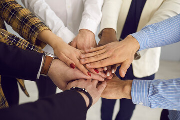 Wall Mural - Closeup shot of hands team. Diverse business people, worker group or friends standing together holding arms stack demonstrating teamwork and partnership. Diversity and communication concept