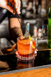 Bartender Hands Making a Perfect Negroni Drink Step by Step Recipe at the bar