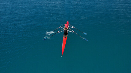 Wall Mural - Aerial drone top down photo of sport canoe operated by team of young women in emerald calm sea waters