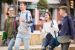 © JackF - Smiling teenage friends spending time together and talking to each other near college building on a sunny day