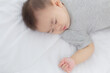 © N_studio - Portrait of asian little baby girl sleeping on bed in the bedroom at home, newborn napping with cozy and relax, infant innocence in bedtime, happy toddler cute, growth of child and emotion, indoors.