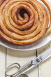 Top view of scissors and homemade churros on a plate
