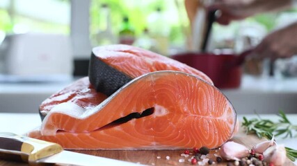 Wall Mural - Fresh raw salmon fillet steaks on a cutting board in the kitchen