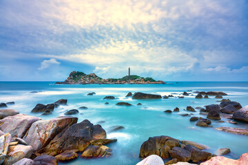 Ke Ga Lighthouse with surf patted smoother reefs create clouds on the sea as this is the only ancient lighthouse is located on the island in Vietnam