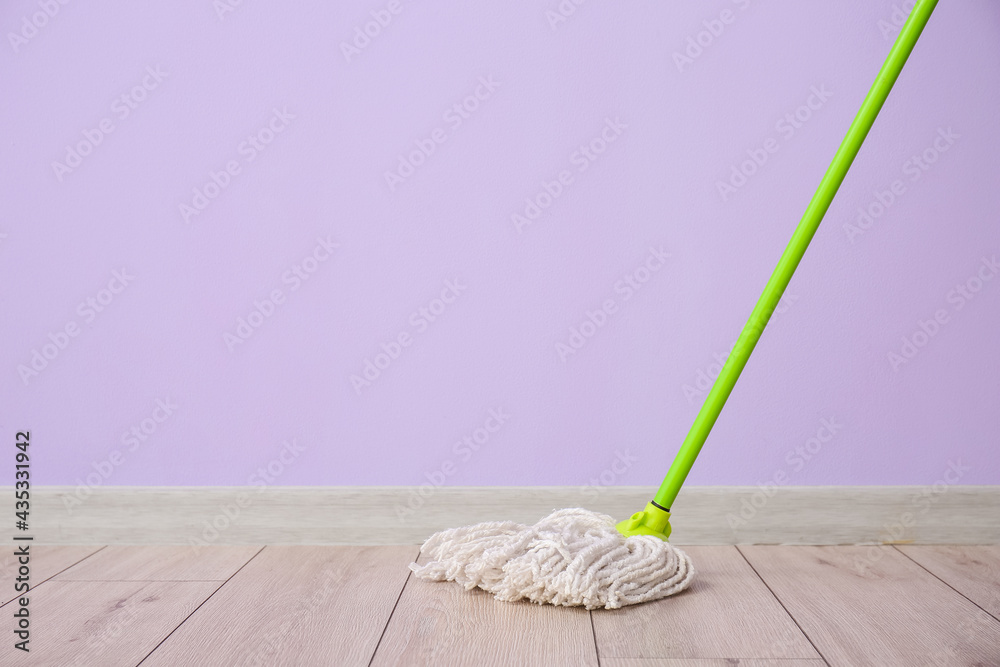 Floor mop near color wall