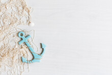 Sea Background With Fishing Net, Anchor And Seashells Top View On White Wooden Background.