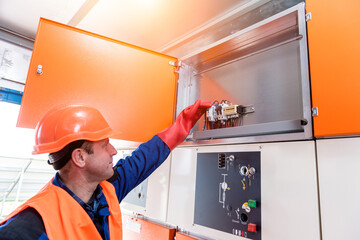 Wall Mural - the engineer checks the absence of induced voltage on the high voltage cells