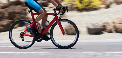 Wall Mural - Road bike cyclist man cycling, athlete on a race cycle. Panning technique used